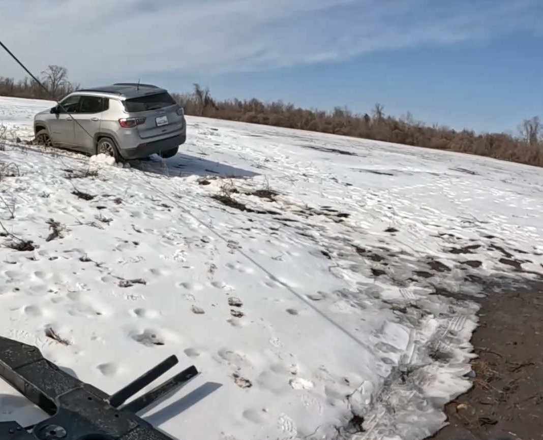 SUV winched from a snowy slope